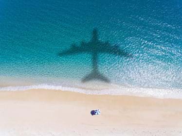 Plane shadow over beach